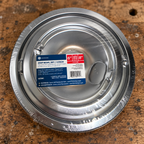 GE GE68C sealed four-pack chrome drip bowls in kitchen setting 2; AI-generated lifestyle illustration