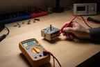 Multimeter testing continuity on a stove range control switch