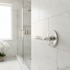 Spa-like master bathroom with white marble tiles and gleaming chrome lever handle and escutcheon