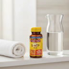 Nature Made 5-HTP 100mg Chewable bottle on minimalist bathroom vanity with rolled cotton towel and water pitcher