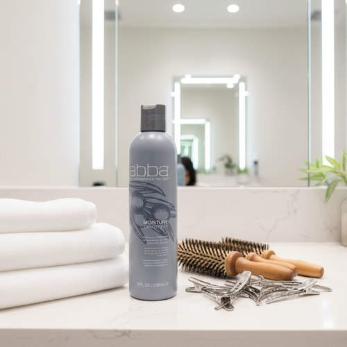 ABBA Moisture Conditioner 8 oz at upscale salon styling station with boar-bristle brushes and white salon towels