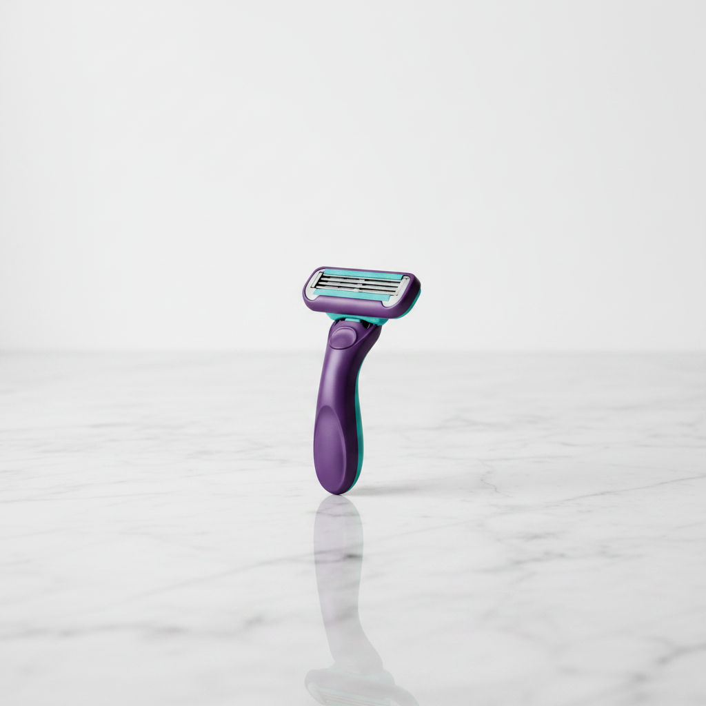 Minimalist purple and teal razor cartridge on a reflective white marble bath surface