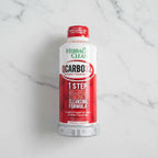 Overhead flat lay of Herbal Clean QCarbo32 health supplement drink bottle on white stone counter, clean neutral background