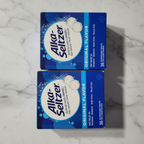 Two Alka-Seltzer boxes on marble countertop