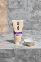 Rodan and Fields UNBLEMISH Invisible Matte Defense SPF 30 tube on a light grey stone surface with soft morning light and white ceramic dish – More4less Outlet