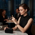 Stylish woman in black outfit checking time on gold-tone Barbie watch with black strap and crystal dial