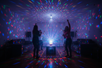 Bright rotating multicolor LED lights filling a dark living room creating a vibrant party atmosphere