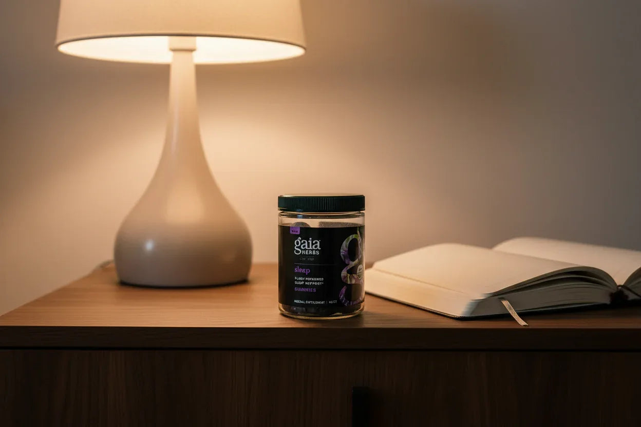 Gaia Herbs Organic Sleep Gummies 40ct on dark oak nightstand with lamp and journal — nightly wellness supplement routine