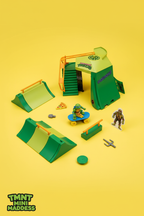 TMNT Mini Madness Skate Park playset flat lay on yellow background with Leonardo figure and accessories