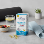 Curated healthy routine aesthetic with premium omega-3 CoQ10 supplement box on natural stone surface