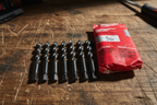 Milwaukee Thunderbolt Black Oxide Drill Bits close-up showing 135-degree split point tips and 3-flat shank on workbench - More4less Outlet