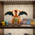 MEGA Pokémon Charizard building set assembled and displayed on collector shelf alongside Pokémon figures and trading cards