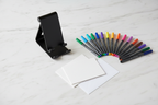 Cupixel phone stand and 12 dual-tip artist markers greeting card set flat lay — More4less Outlet