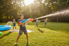KEY 049 large water blaster toy in sunlit backyard grass field action play setting