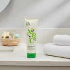 Arbonne Baby Care ABC Hair and Body Wash 8 oz on bathroom vanity with white towels and nursery elements