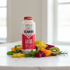Herbal Clean QCarbo 16 red and white bottle on white marble beside fresh tropical fruits and green herbs – More4less Outlet