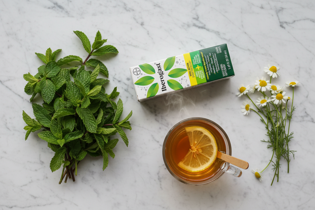 Green herbal supplement box next to peppermint leaves, chamomile flowers, and warm tea on marble
