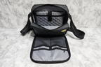 Solo New York Ludlow tablet sling flat lay on marble showing padded tablet compartment and front zip organizer — More4less Outlet