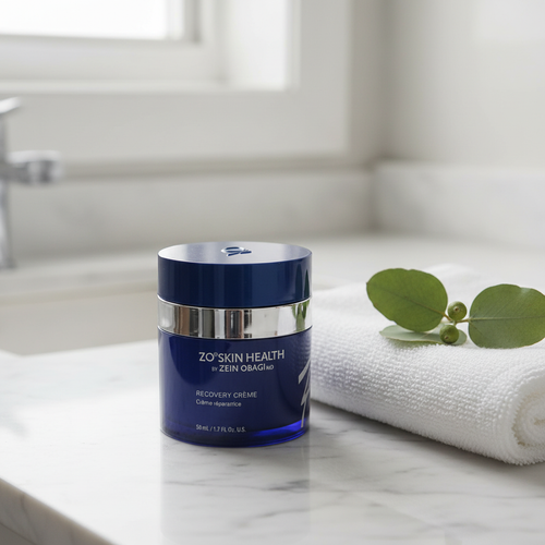 ZO Skin Health Recovery Crème navy blue jar on white marble vanity with towel and eucalyptus