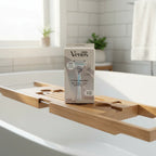 Gillette Venus Pubic Hair & Skin Razor Kit on oak bathtub caddy near white porcelain soaking tub in morning light