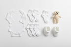 Six pairs Gerber Baby Wiggle Proof Stay On white socks flat lay with newborn essentials – More4less Outlet