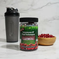 Irwin Naturals Testosterone UP Gummies bottle on modern granite kitchen counter with shaker bottle and wooden bowl of pomegranate seeds