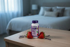 Natrol Melatonin 5mg on bedroom dresser with strawberries and lavender wellness lifestyle