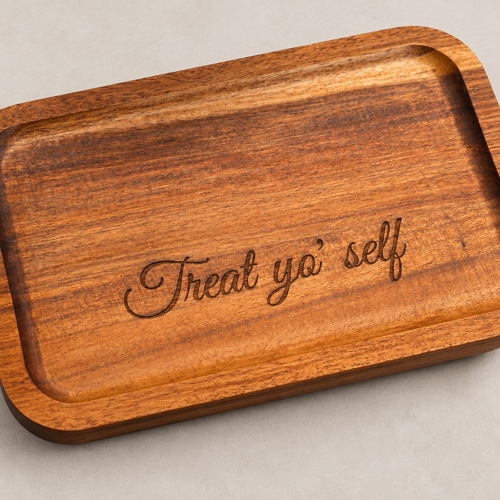Angled detail of Treat Yo' Self engraving on acacia wood tray