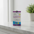 Clean lifestyle photo of Nordic Naturals supplement box resting on natural stone vanity surface