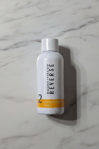 Rodan + Fields REVERSE Intensive Brightening Toner sealed white bottle on neutral marble background