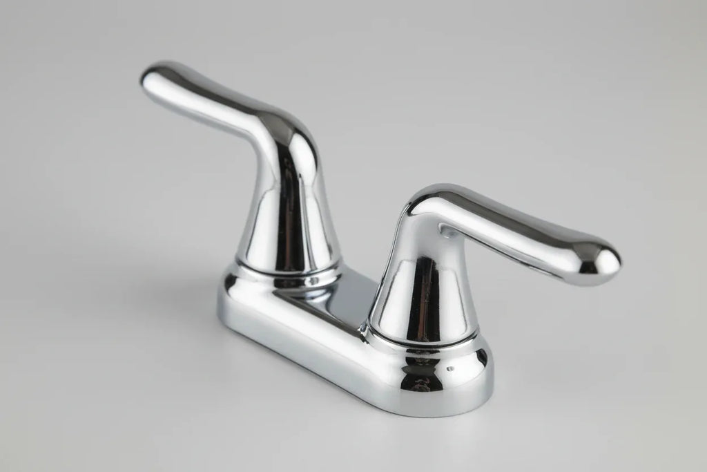 Macro studio shot of smooth reflective chrome finish on American Standard Cadet faucet lever handles