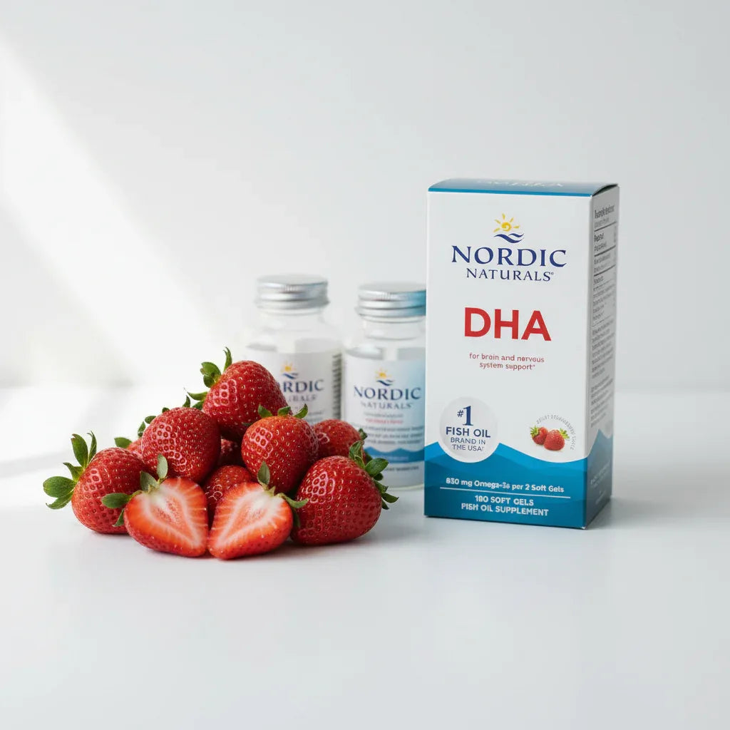 Vibrant fresh strawberries placed next to modern dietary supplement bottles on a clean white surface