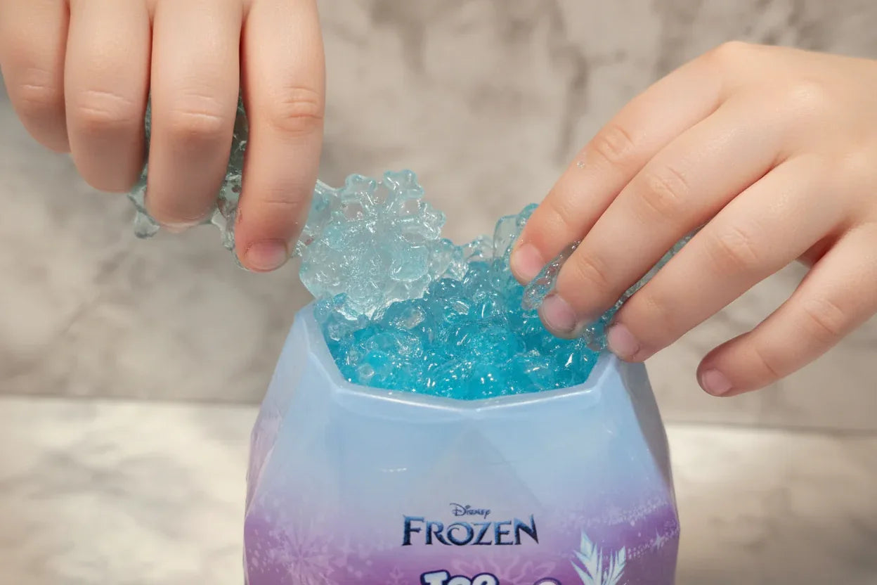Child scooping into Disney Frozen Ice Reveal Squishy Ice gel to discover hidden surprises