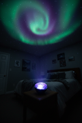 National Geographic Aurora Light Projector projecting green purple and blue northern lights across dark bedroom ceiling