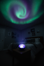 National Geographic Aurora Light Projector projecting green purple and blue northern lights across dark bedroom ceiling