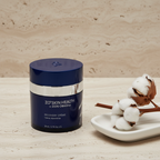 ZO Skin Health Recovery Crème navy blue jar on travertine stone surface with ceramic tray and cotton stem