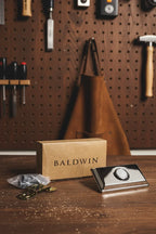 Baldwin Rectangular Doorbell Button Chrome hardware kit on craftsman workshop tool board