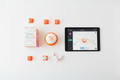 Sphero Mini orange robotic ball STEM flat lay with retail box tablet showing Sphero app mini cones and bowling pins – More4less Outlet
