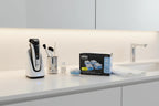 Modern uncluttered bathroom vanity setup showing premium electric shaver care items