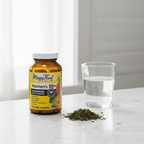 Women's advanced multivitamin amber glass bottle beside water glass and green tea leaves on white marble countertop – More4less Outlet