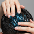 Fingers applying blue hair gel through short hair showing high shine hold close-up lifestyle photo