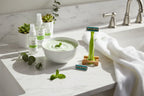 Morning sunlight highlighting a smooth shaving routine with fresh green aesthetic on white marble bathroom counter