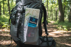 DripDrop Bold Variety Electrolyte Pack 8ct in backpack mesh pocket with trail map and sunglasses — outdoor travel hydration kit