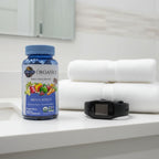 Garden of Life Mykind Organics Men's Multi bottle on white quartz bathroom vanity shelf with premium white linen towels and tech fitness watch