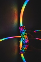 Colorful remote control reflecting onto sleek LED mirror surface with rainbow RGB glow