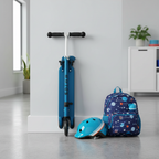 Blue folding kick scooter folded flat leaning against wall next to helmet and backpack — Jetson Jupiter compact storage — More4less Outlet