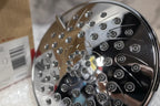 Macro detail of precision water nozzles and high-gloss polished chrome finish on round shower head