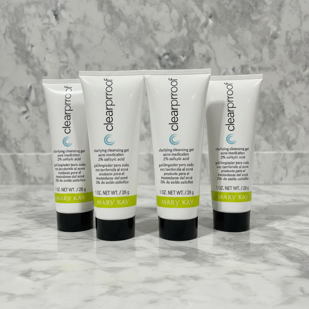 Four Mary Kay Clear Proof Clarifying Cleansing Gel tubes standing upright on grey marble - studio shot