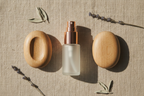 Calming lifestyle flat lay of Lifelines essential oil precision pump bottle and two oval meditative fidget stones on soft linen