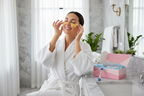 Woman applying Rodan + Fields gold eye mask in white bathrobe spa lifestyle - More4less Outlet